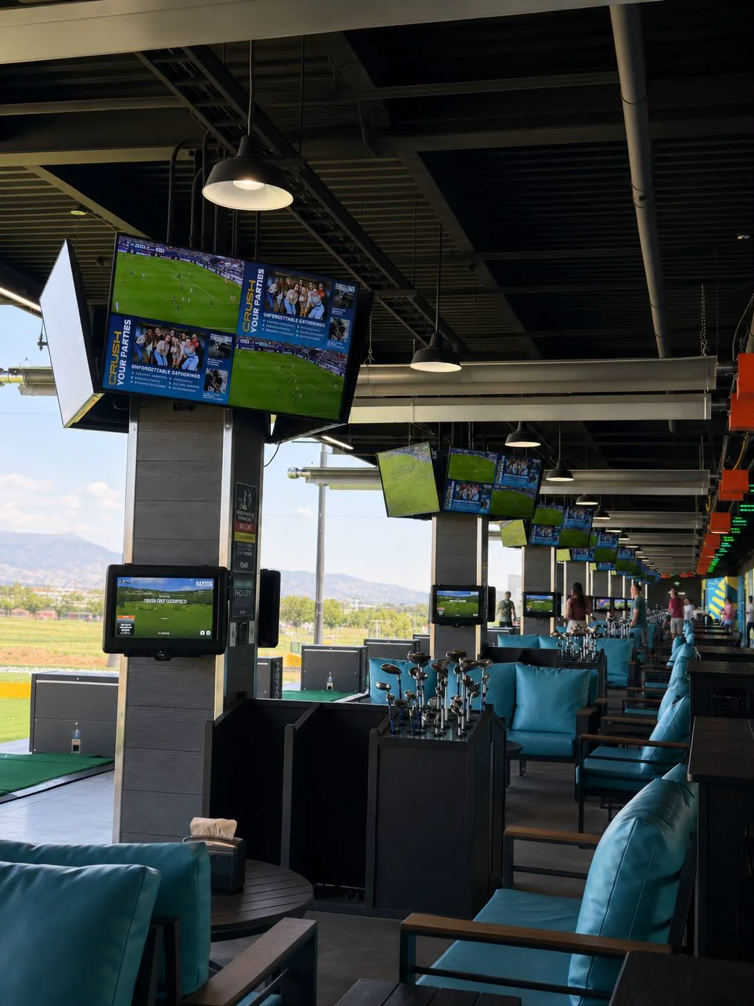 Crush Golf & Grill guest bays with lounge seating and displays